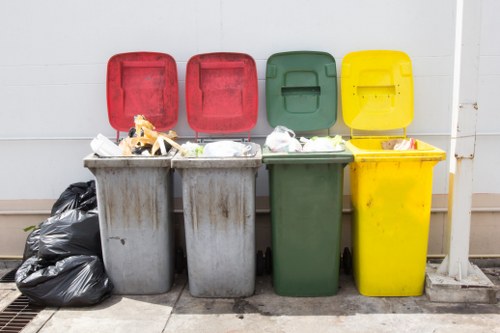 Frontline commercial waste crew preparing bins for collection in an urban service area
